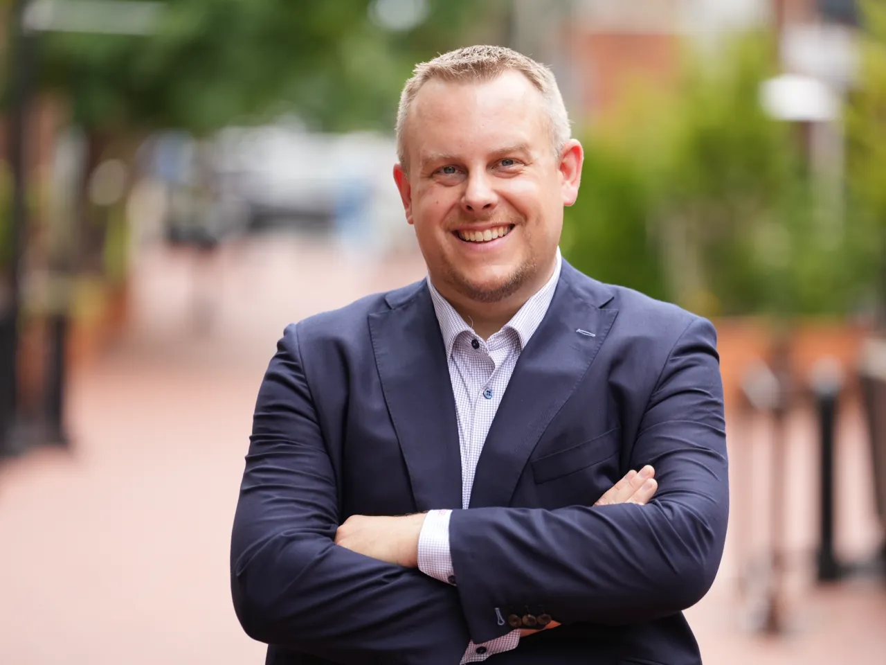 Aaron Evans, founder and CEO of Story Group, smiling with arms crossed